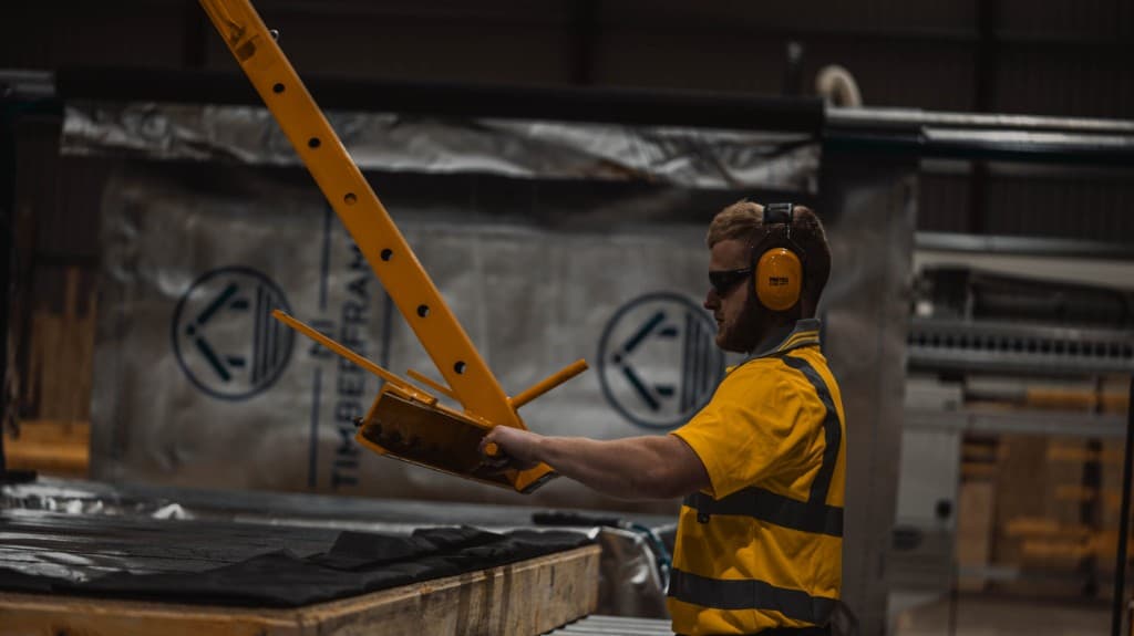 Skilled worker operating timber frame machinery